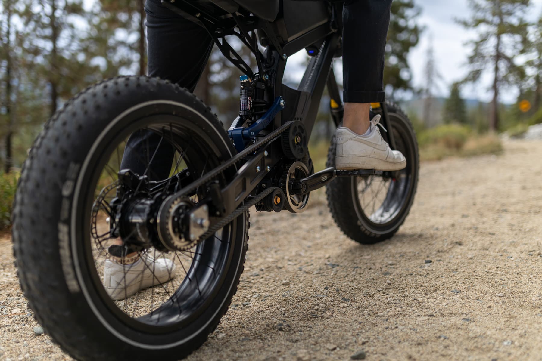Close-up of the REVV e-bike's belt drive and full suspension