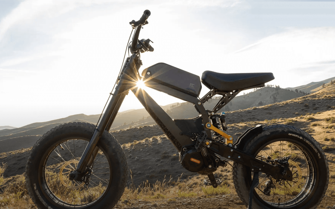 REVV fat-tire e-bike silhouetted against a desert sunset, ready for Burning Man